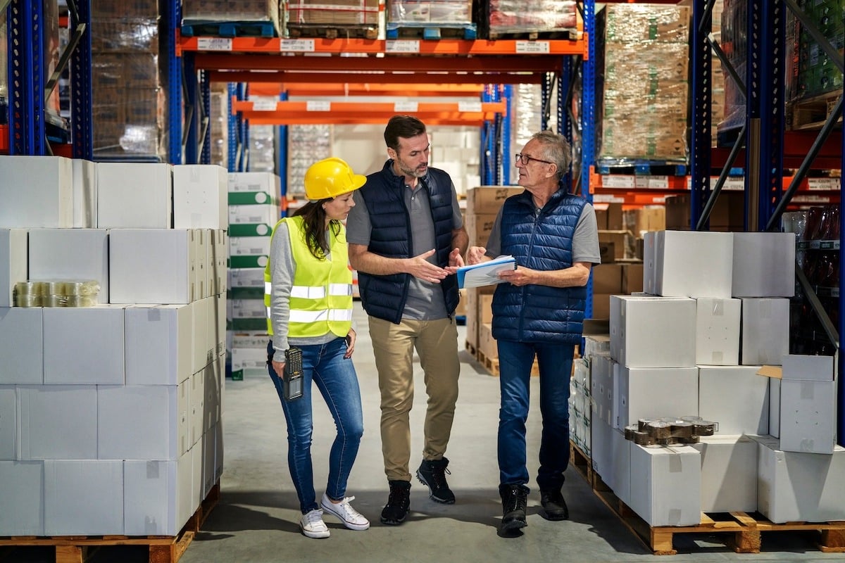 colleagues discussing the future of new product information management on a factory floor